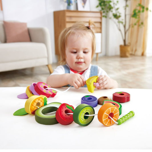 Best toy shop in Qatar – Hape Caterpillar Fruit Feast Set displayed with caterpillar strings and fruit pieces, ideal for toddler learning, available to buy kids toys online in Qatar with toy delivery service in Qatar.