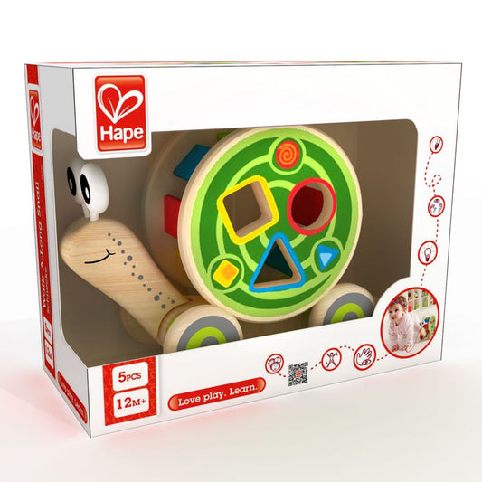 Best toy shop in Qatar – toddler playing with Hape Walk-A-Long Snail, learning shapes and colors while pulling the toy, available from the best online toy shop in Qatar with toy delivery service in Qatar