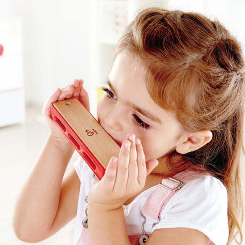  child playing with Hape Blues Harmonica musical toy, perfect gift to buy kids toys online in Qatar from the best online toy shop with fast toy delivery service in Qatar.