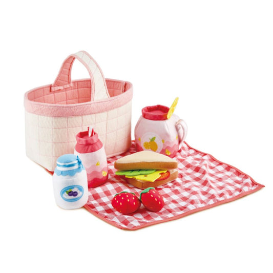 Kids playing with Hape Toddler Picnic Basket – includes pretend food, picnic cloth, and sponge-soft toys.