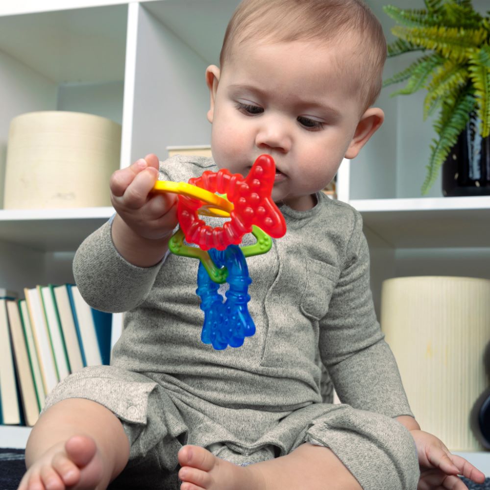 Baby holding and chewing on animal-shaped teether – best online toy shop in Qatar