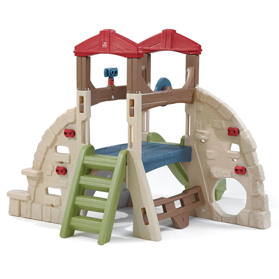 kids outdoor playhouse Qatar -A colorful outdoor playset featuring a climbing structure with multiple climbing walls, a slide, and a crawl-through tunnel.